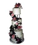 four tiered wedding cake with garkand of live flowers