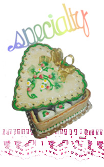 graphic of an edible gift box containing petits fours decorated by a decorative font reading specialty